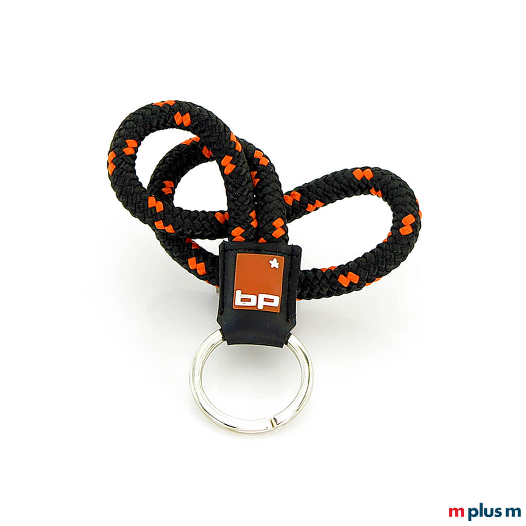 Schwarz-orangener Schlüsselanhänger mit Logo bedruckt Schwarz-orangener Schlüsselanhänger mit Logo bedruckt